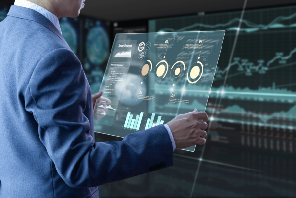 A man with a screen with investment graphs showing portfolio rebalancing and analytics capability of Thinking Wealth Investment app